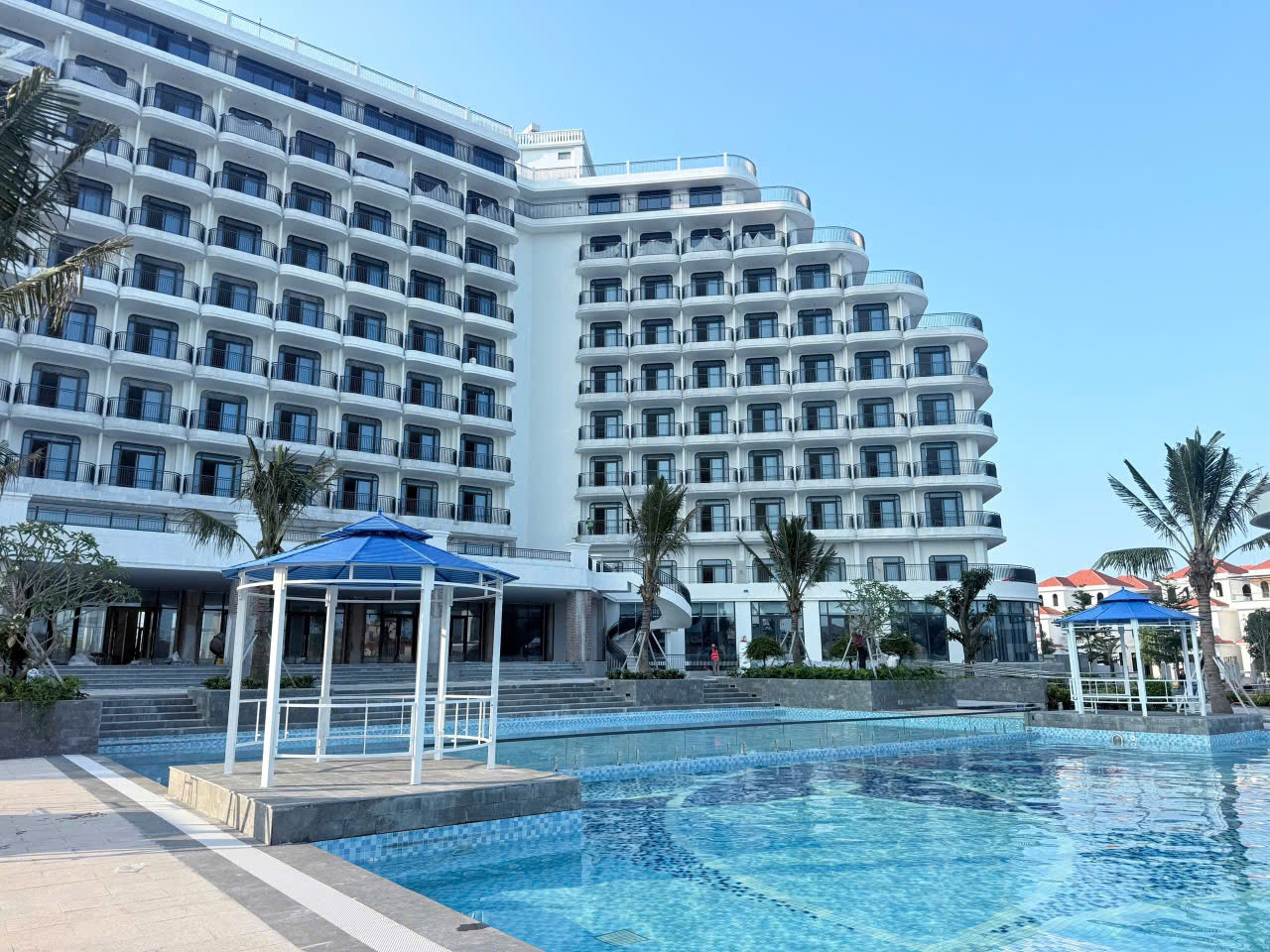 Khung cột sơn màu trắng, mái màu xanh dương rất hợp với khuôn viên bể bơi